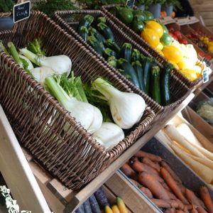 local shop fruit & veg shelving, wicker baskets, wooden display stand