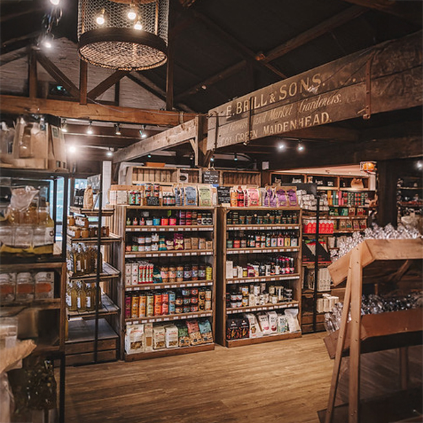 Grocery store fixtures in natural finishes. Country store shelving, fitting out a barn for healthy goods.